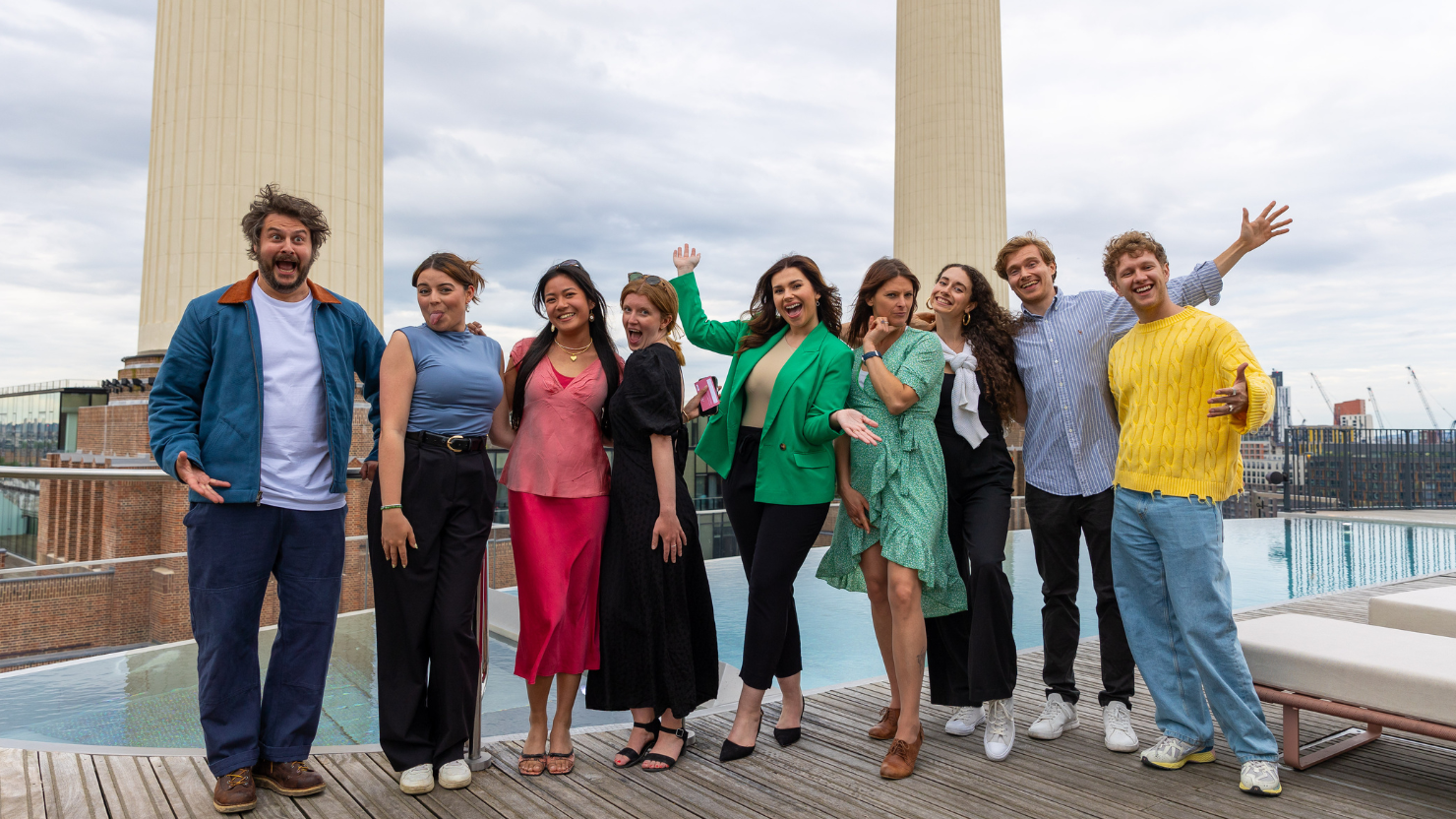 Team from the Felix Project and Farrer Kane & Co stand in front of Battersea Power Station chimneys at launch of Restaurants Feed London